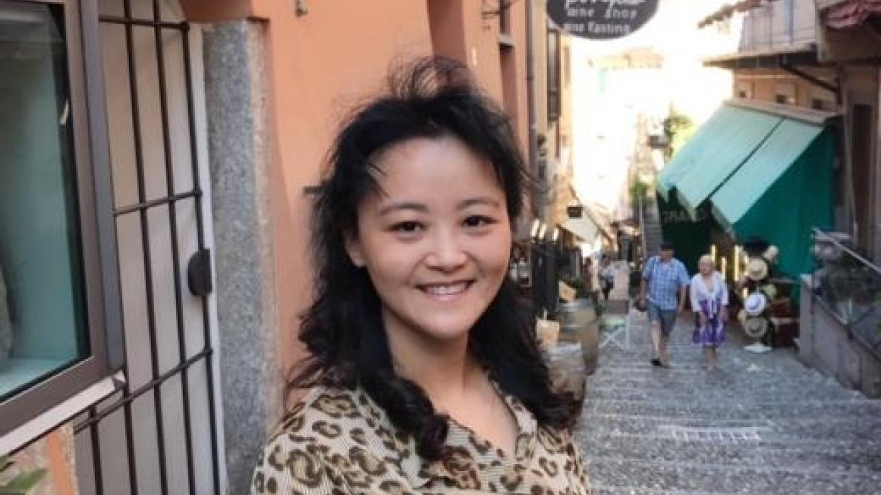 Qi Zhang, professor of environmental toxicology, is among 19 UC Davis researchers whose highly cited work has been identified as amongst the most influential in their fields in an annual survey. Image: photo of Qi Zhang, who stands in front of an outdoor shop.