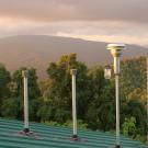 Image: inlet stacks of monitoring station surrounded by forested mountains.